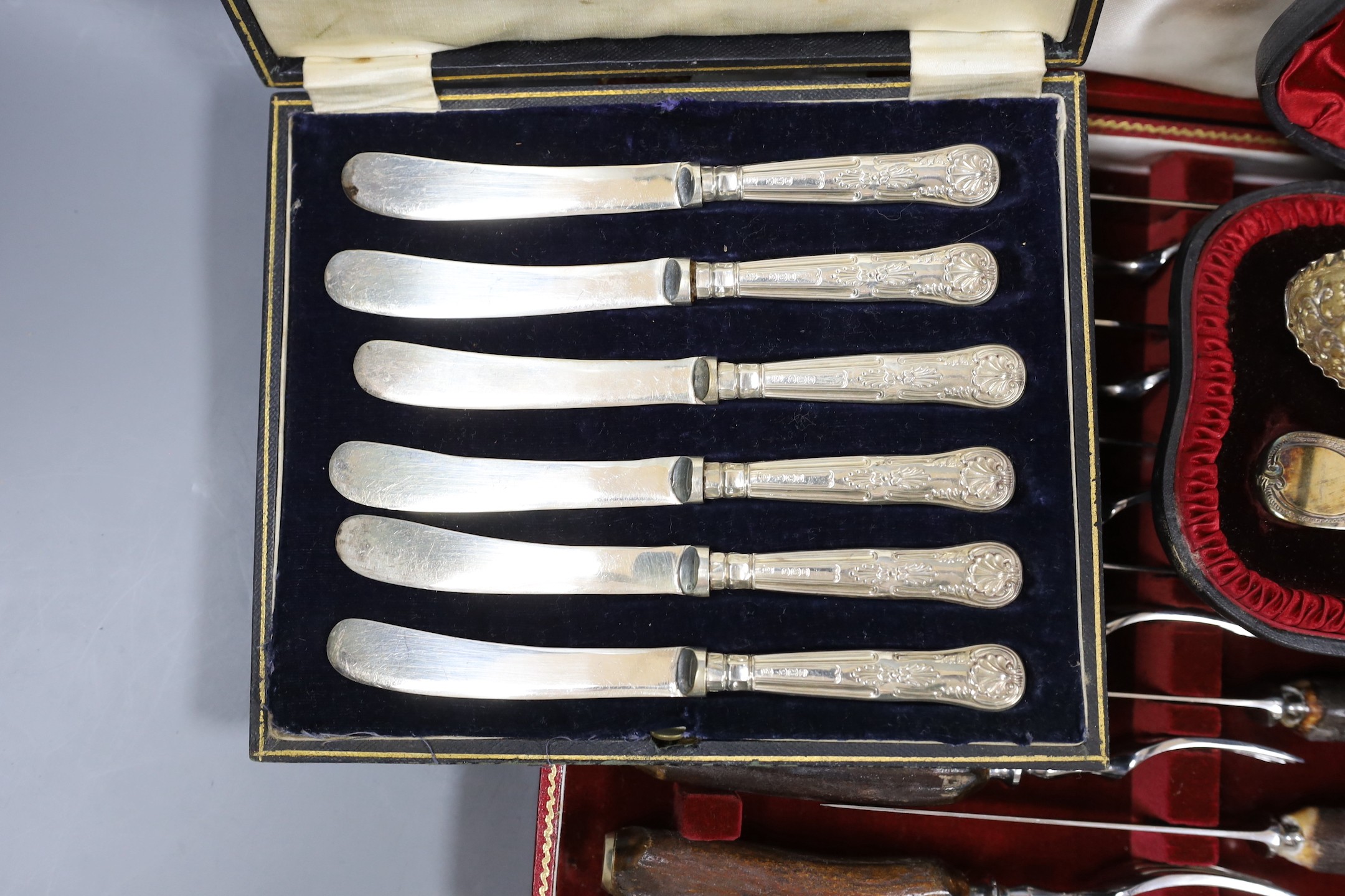 Four cased sets of flatware, including silver 'berry spoons', tea knives, teaspoons and horn handles knives and forks.